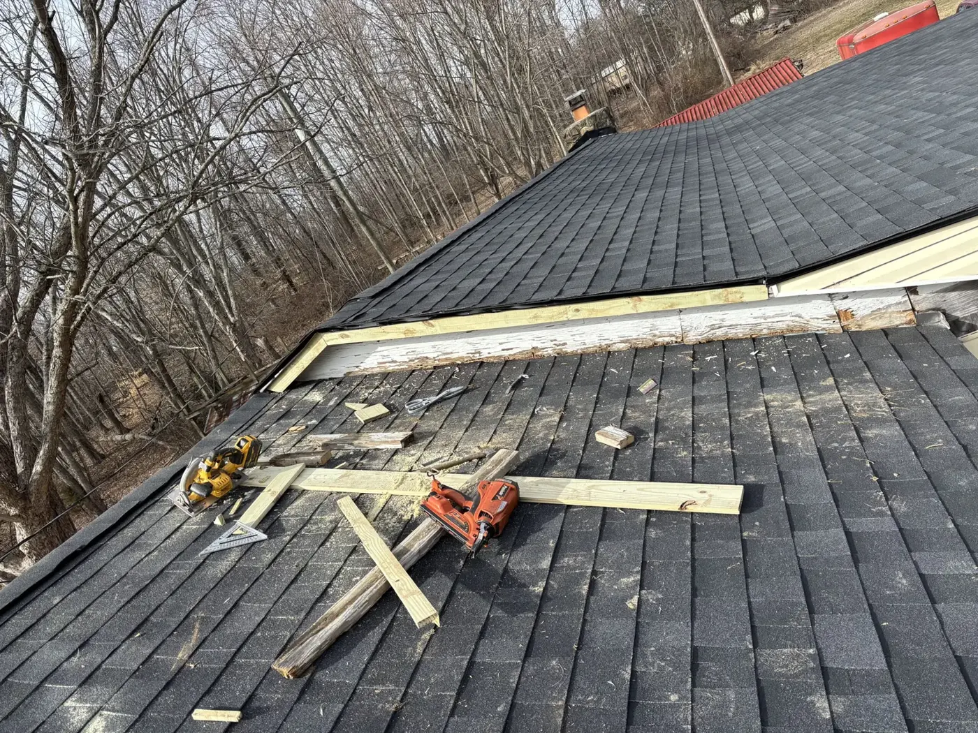 Roofing work in progress with tools on the roof