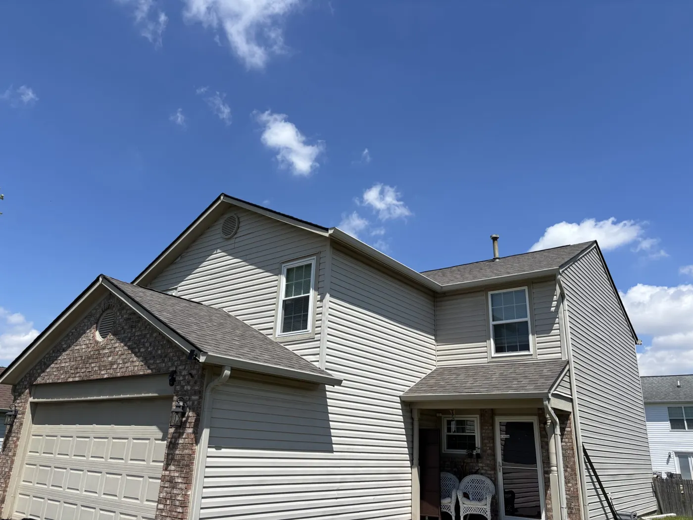 Two-story home with a shingle roof