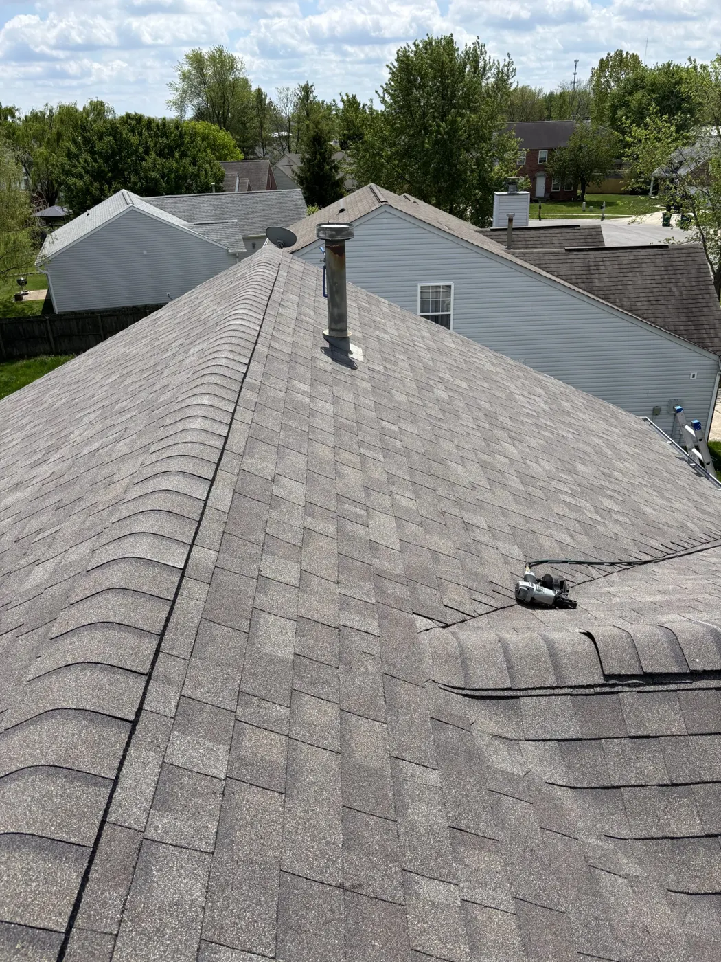 Shingle roof with pipe vent and ridge line